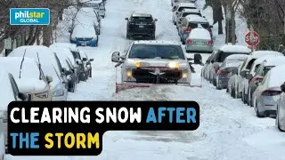 Workers clear snow off the streets of Washington after storm