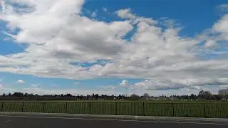 Middle then bottom of the horizon at 0:21. Consider how far away and big the clouds are.