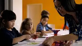 young teacher checking her little students work | Free Stock Footage - No Copyright