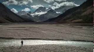 4k 60fps aerial of woman by athabasca rive in jasper