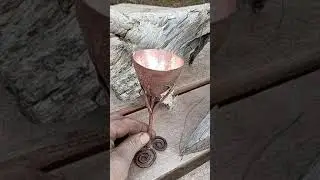 Raised copper chalice with trefoils and tree motif.