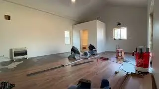 Installing vinyl floor plank over pressure sensitive glue.