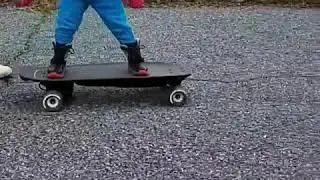 2 year old rides a  boosted board