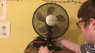 This is a AirArtDeco black 12 inch oscillating desk fan