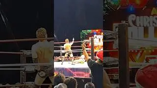 Okada flipping off the camera and Mike Bailey