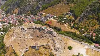 Fethiye, Turkey. Aerial drone view of Fethiye Castle ruins with large Turkish flag on flagpole on...