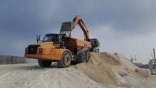 Cat dump truck sand loading by cat excavator 