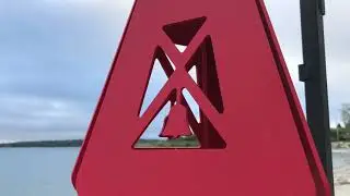 Red Compass Rose Buoy Bell on the beach in Maine at dawn.