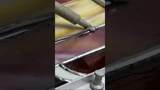 Soldering a stained glass panel.