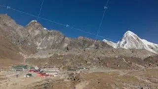 Aerial perspective of a serene mountain village in Nepal, displaying classic architecture and snowy