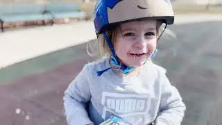 2 year old on a balance bike doing tricks.