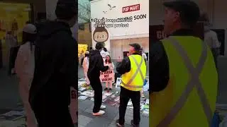 Eating a burger in front of vegan protest