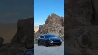 Satin Black Tesla Model Y in the rocks