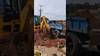 JCB 2DX LOADING MUD INTO TRACTOR USING BACK BUCKET