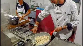 Castelmagno Cheese Melted over Italian 'Gnocchi' Dumplings. Street Food from Italy
