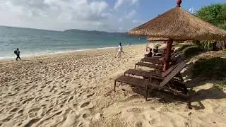 The crescent-shaped sandy beach at Yalong Bay sits in its own wildflower-filled coastal park.