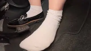 Driving wearing one shoe with white socks 