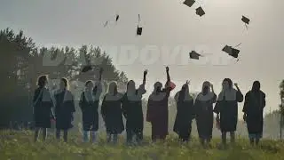 Graduates are celebrating throwing their graduation caps in the air