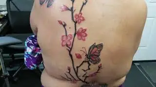 Cherry blossom tattoo on female back by Boris  Kuryakin, April 02, 2019.