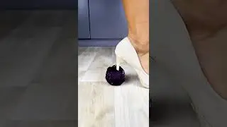 White stilettos step on fruit