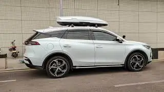 The BYD Tang DM is installed with a roof box. The white G5 model of NEUMANN roof box