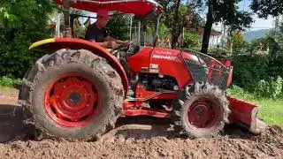 The bulldozer digs up the soil to make a road.