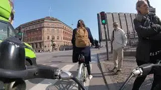 Sunlit Adventure: Thrilling Bike Ride through Copenhagen's Vibrant Streets on a Windy Afternoon