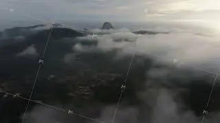 Aerial footage of the Ibiza landscape flying through morning clouds. Beautiful view of mountains and
