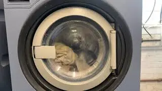 Miele Professional PW6080 commercial washing machine running a quick wash programme with towels.