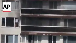 Dramatic video shows man escaping an apartment fire through a window in Belgium