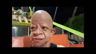 Bald wrinkly man on a Ferris Wheel