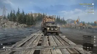 HEAVY DUTY LOGGING TRUCK CROSSING RIVER ON WOODEN BRIDGE