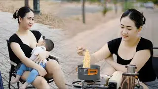Single Mom camping with her children in the wild. Breastfeeding, grilling meat