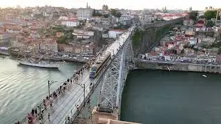 Metro on the Ponte Luis 1 bridge in Porto passing by with ships in the Douro river