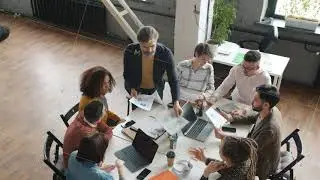 High angle view of creative business team discussing smartphone applications design in office