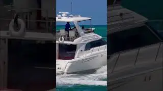 Sea Ray 480 Sedan Bridge on a busy Sunday at the wavy Haulover Inlet