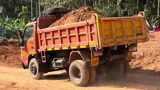 Jcb 3dx loading soil into truck and transporting soil for levelling land