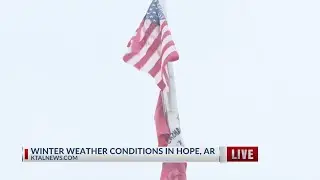 It is so cold in Hope, Arkansas flags are stuck to flag poles in