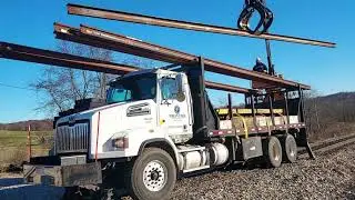 Grapple Truck Loading New Sticks of Rail