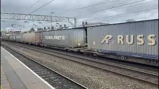 DRS Class 66-009 at speed through Stafford 3/4/2024 with 24 containers and one tanker.