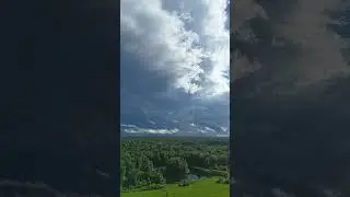 Strong storm approaching, mist rising off the woods