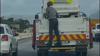 Schoolboy fraudulently climbs behind a truck following lack of transport fares. Very dangerous!!!!!!