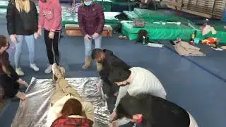 Improvised stretcher using an emergency blanket
