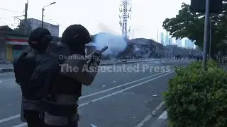 Indonesian police fire tear gas as thousands of protesters try to reach parliament compound