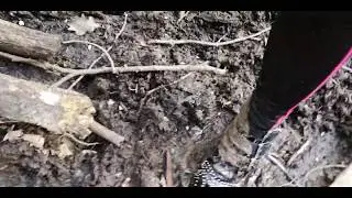 Studded boots sinking in mud