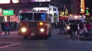 FDNY ENGINE 65 CRUISING BY ON 7TH AVENUE IN THE TIMES SQUARE AREA OF MANHATTAN IN NEW YORK CITY.