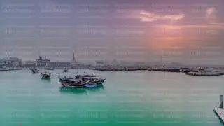 Sunset at Doha Bay timelapse with Traditional Wooden Dhow Fishing Boats.
