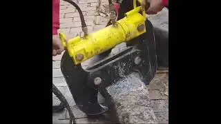 Pneumatic pliers breaking giant concrete block easily