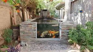 8000 liter Koi pond with chamber filtration and blade waterfall. 1 meter pond window.