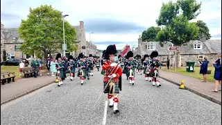 Drum Major leads Ballater Pipe Band march into Tomintoul before the 2025 Highland Games in Scotland